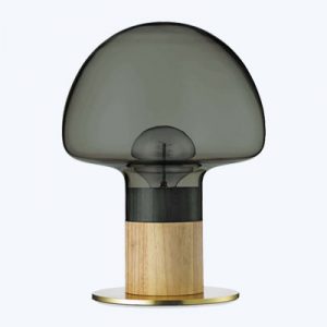 A table lamp with a wooden base and smoke colored glass shade.